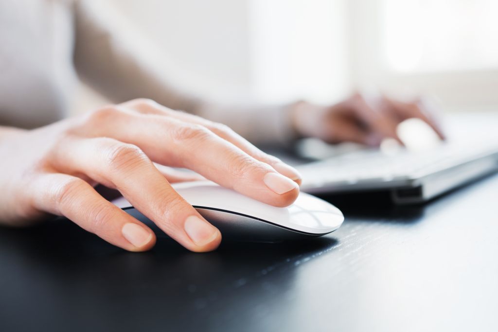Close-up of a woman's hand with computer mouse