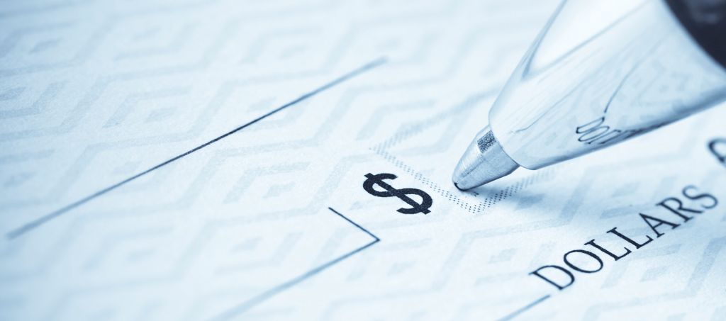 A close up of a pen filling out the dollar amount portion of a check