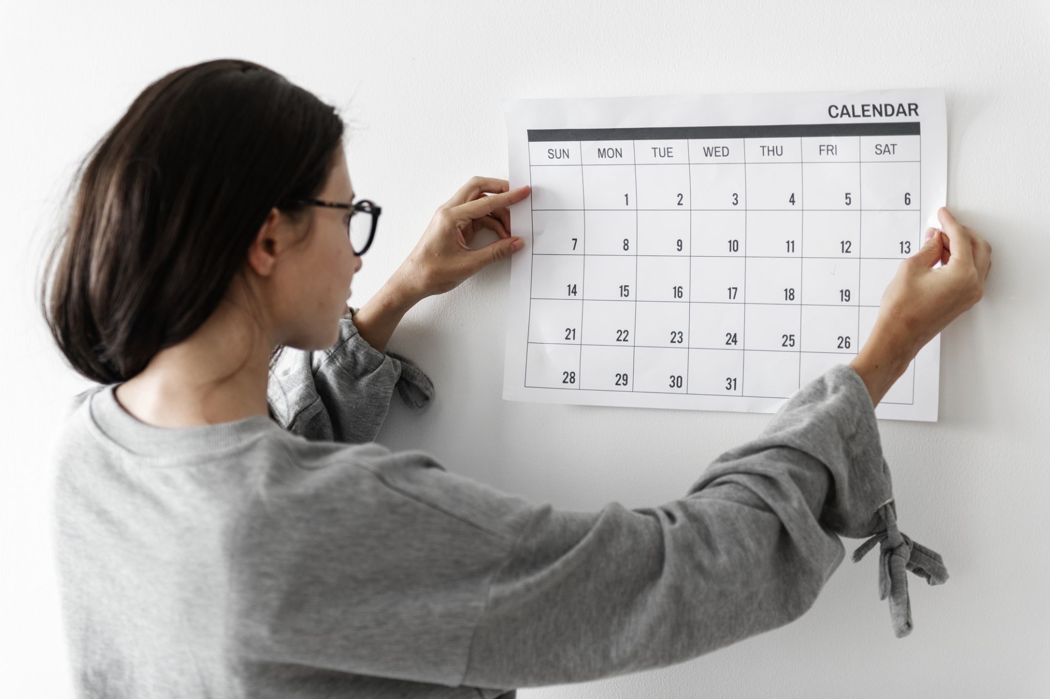 Woman hanging a calendar