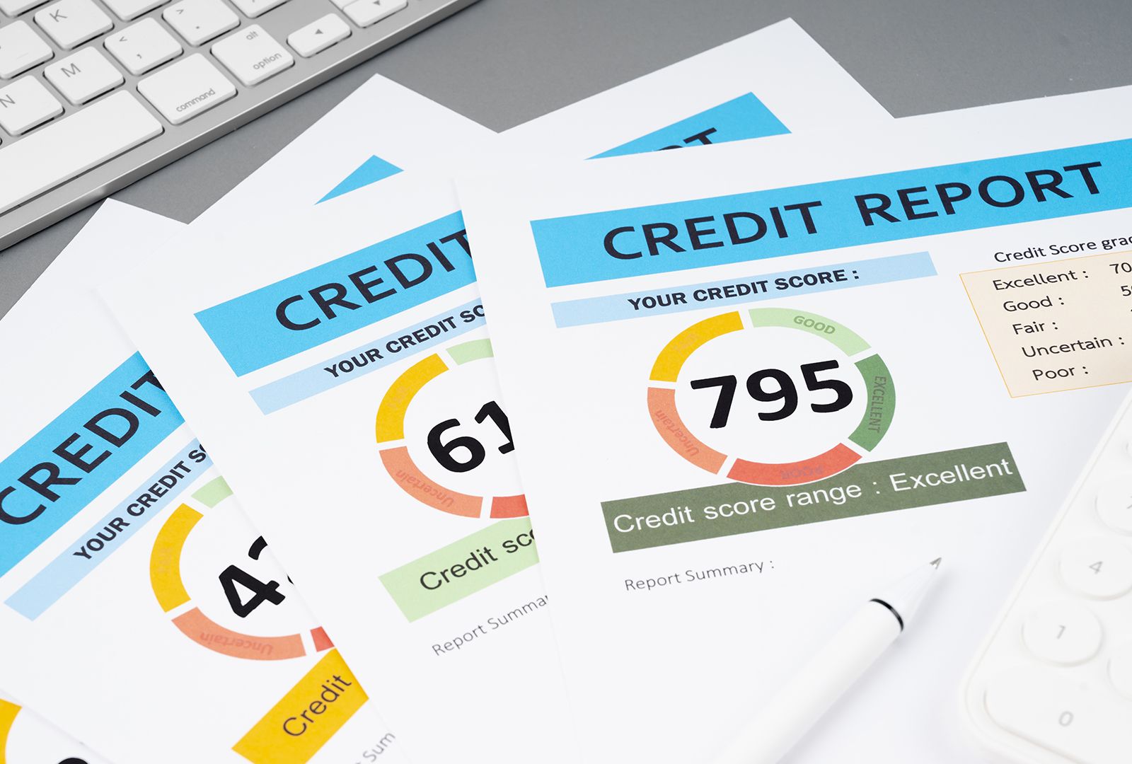 printed credit reports on desk showing rising scores