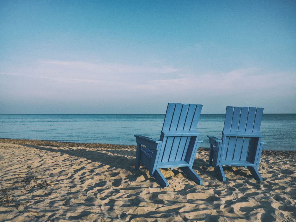 Two chairs on a beach by the ocean